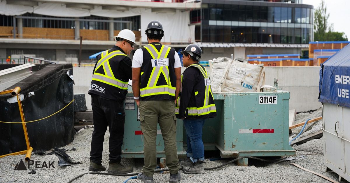 Construction workers reviewing materials beside a street-placed dumpster, highlighting permit duration and placement rules for temporary public space use