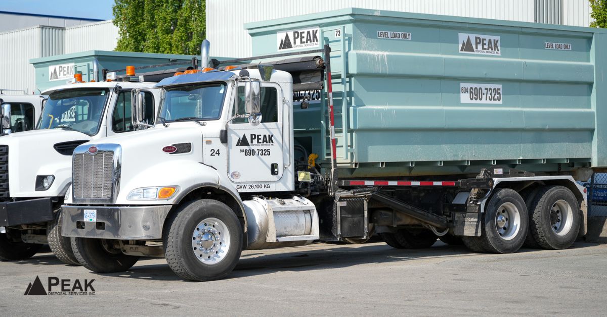 Peak Disposal Services white truck and light green roll-off bin ready for Abbotsford construction projects
