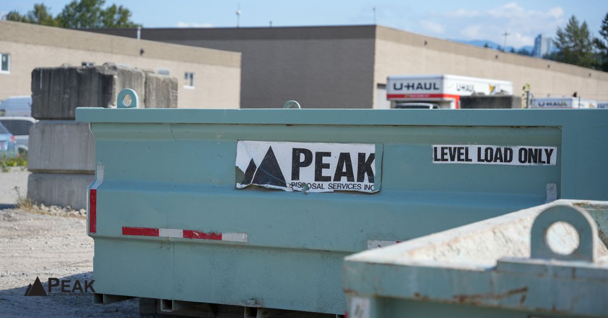 Peak Disposal Services roll-off bin positioned at a Richmond construction site, ready for waste removal under local regulations