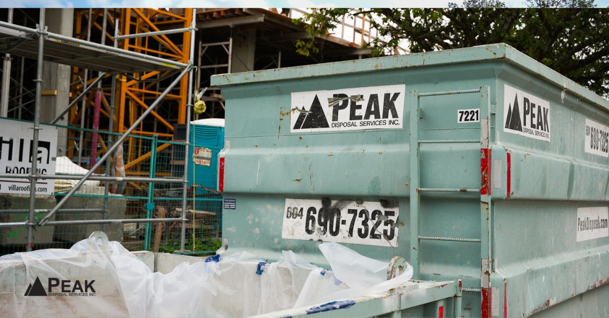 Roll-off construction bin on street near building site in Richmond, indicating permit requirements for public placement areas