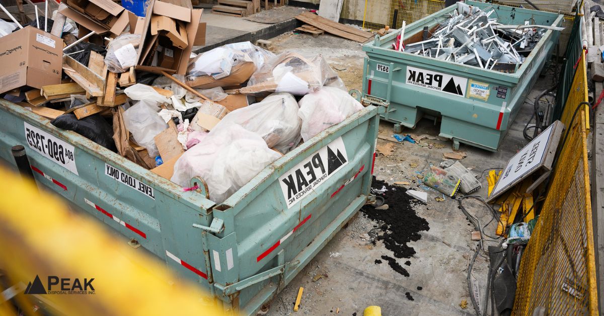 Overloaded roofing dumpsters with mixed debris at construction site, showing common disposal and hauling coordination mistakes.