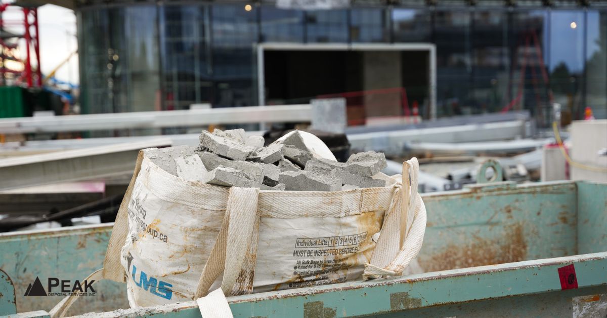 Clean fill bin with separated concrete rubble bag at a construction site, showing organized heavy material disposal.
